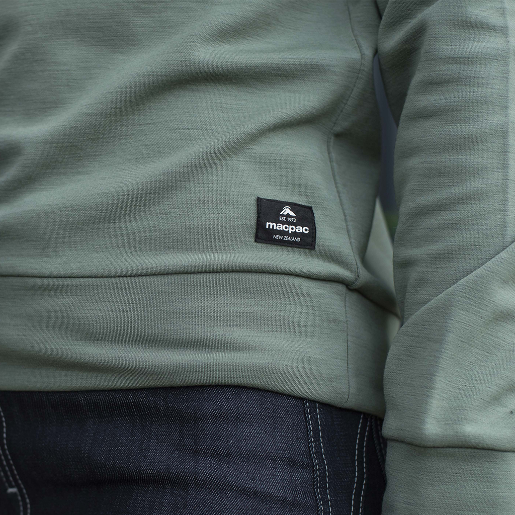 Close up of macpac logo on a merino top in a light mint green colour