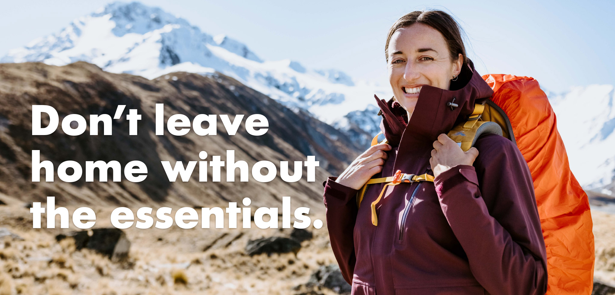 Don't Leave Home Without the Essentials - Woman wearing orange hiking pack near snow covered mountains