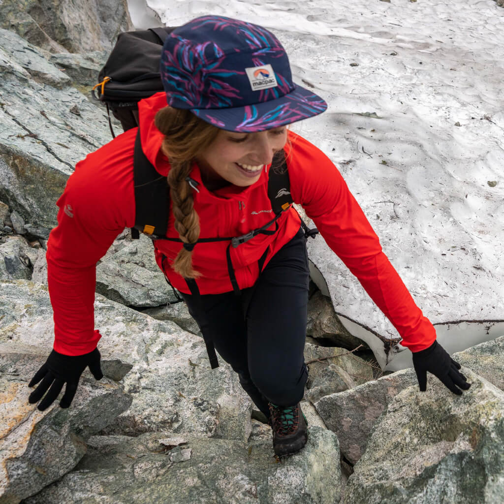 Protection During Activity - Woman Wearing Red Mannering Jacket climbing up rocks