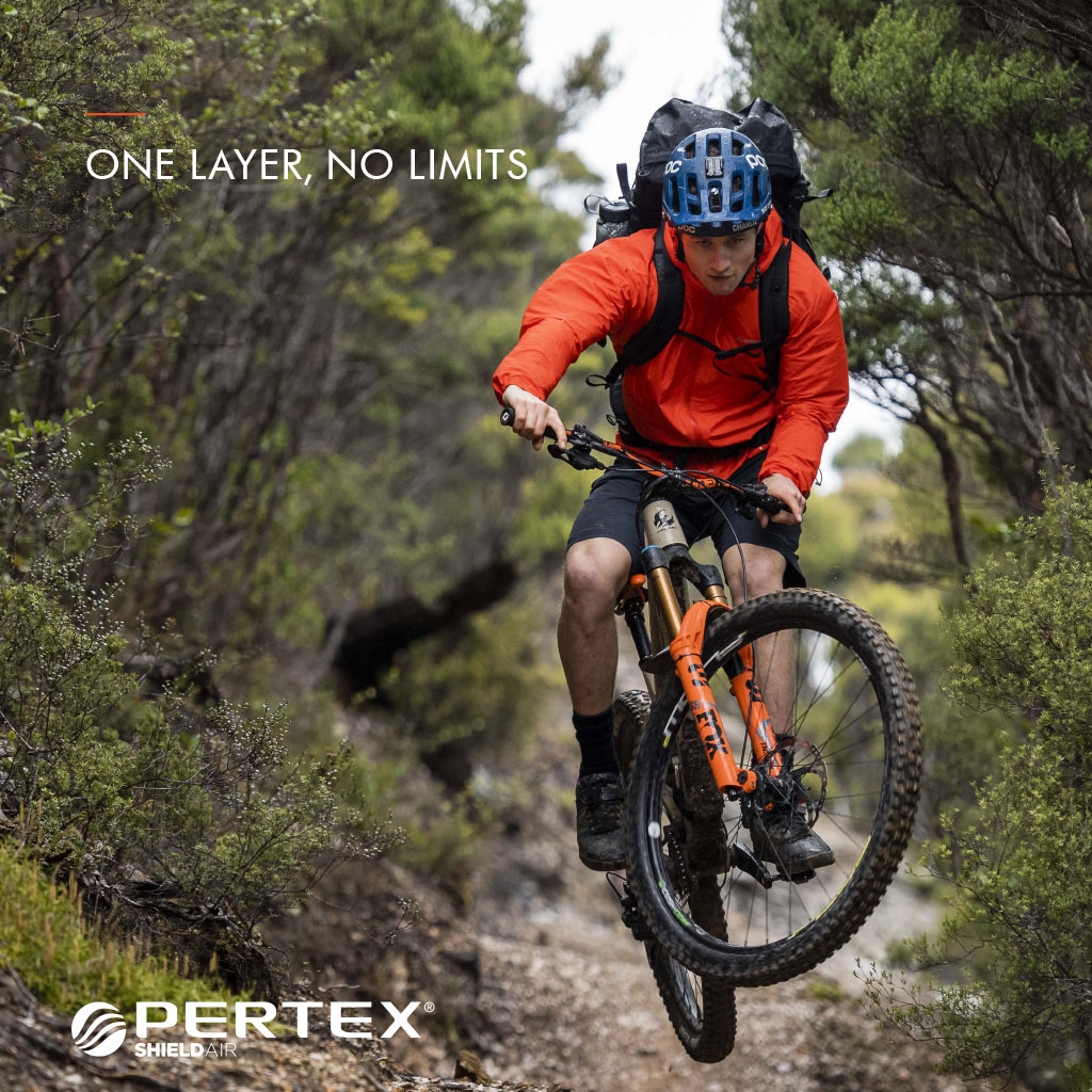 One Layer, no limits - Pertex - Man wearing Orange Jacket, riding bike
