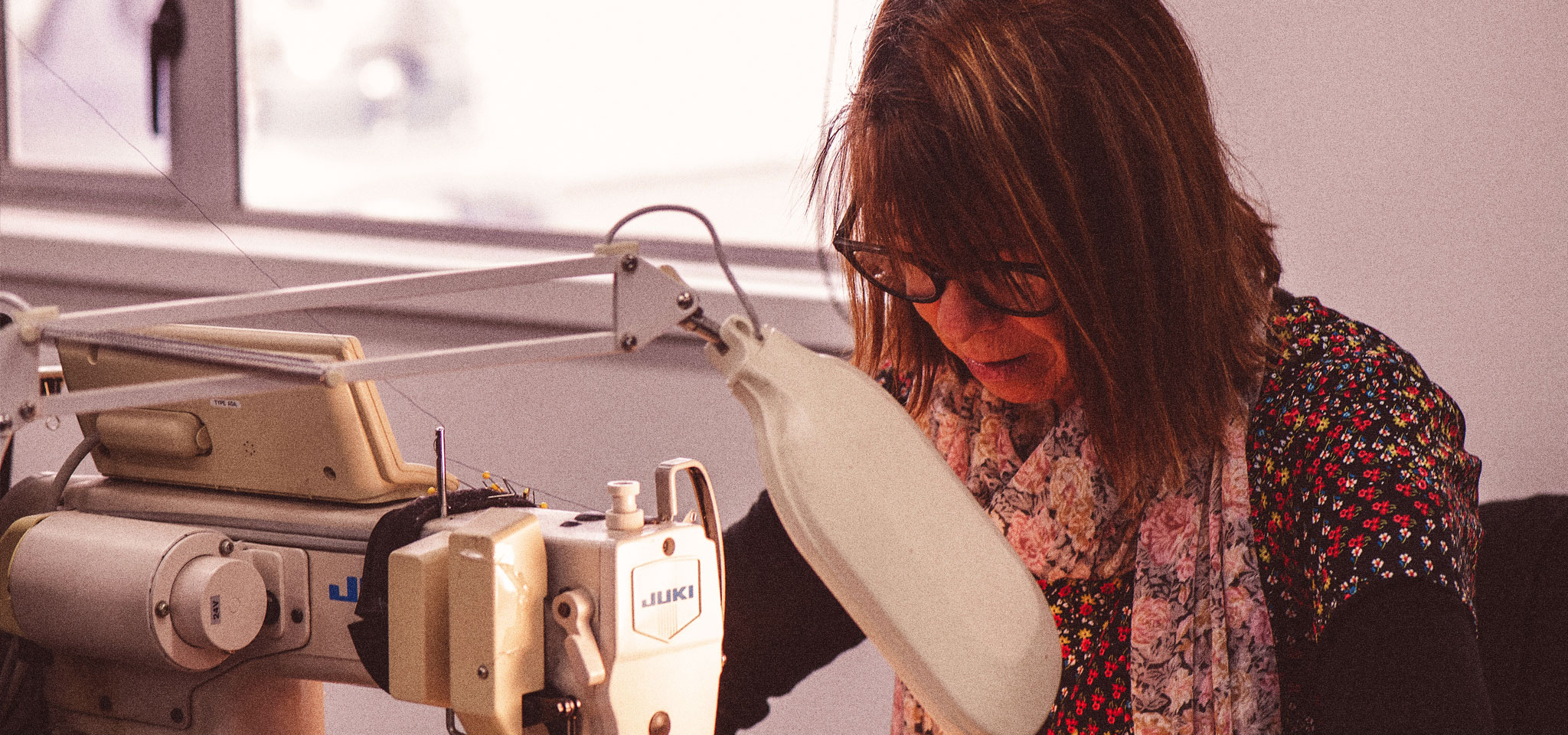 Christine Billing - Repairs specialist, using a Sewing machine at the macpac repairs room