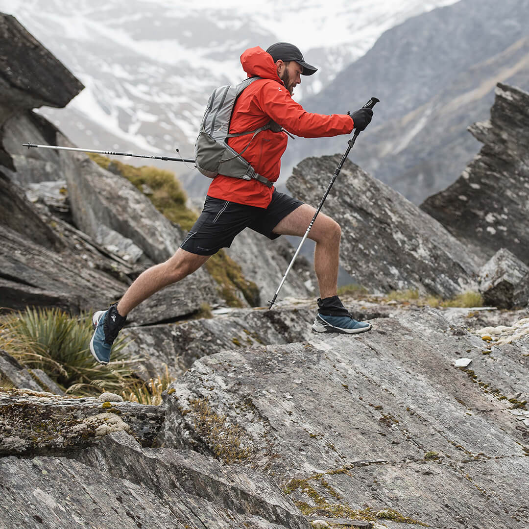 Woman's legs wearing black leggings and hiking boots standing on a rock